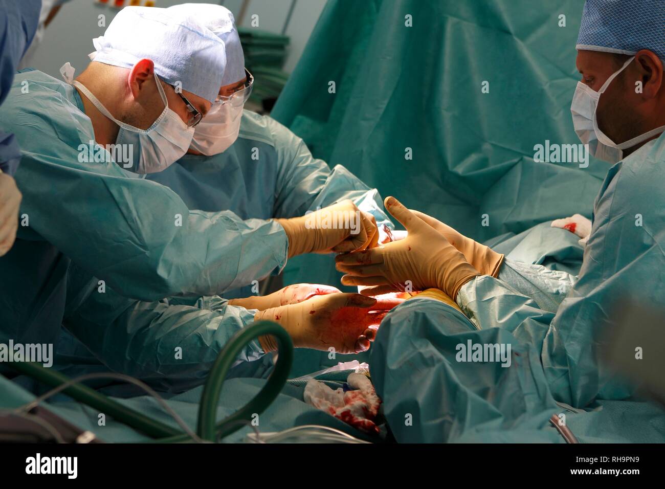 Surgeons during surgery, total hip replacement, surgery department