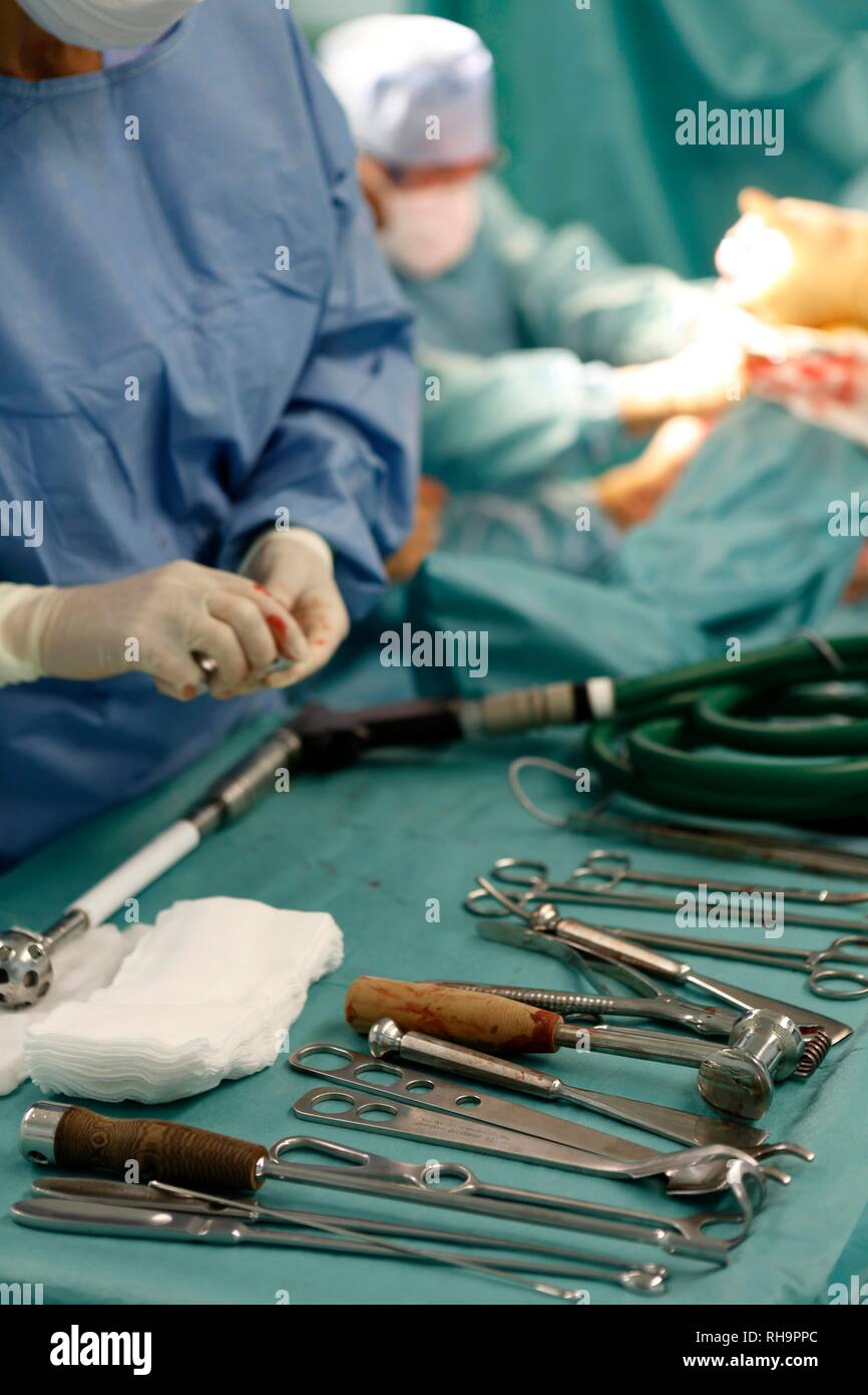 Surgeons during surgery, total hip replacement, medical equipment