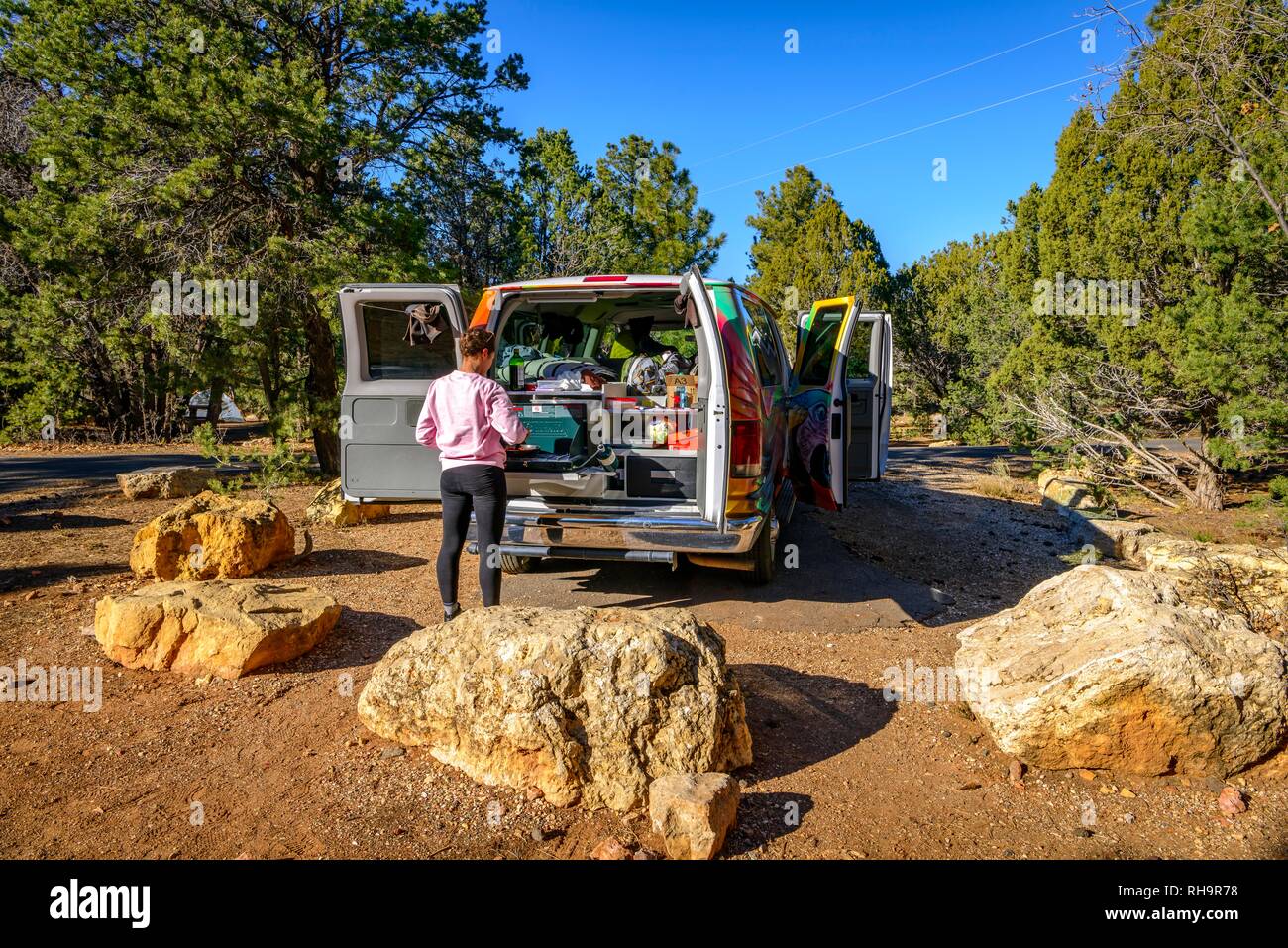 Young woman cooking at the gas stove of a camping van, campervan, camping, RV, Mather Campground, Grand Canyon National Park Stock Photo