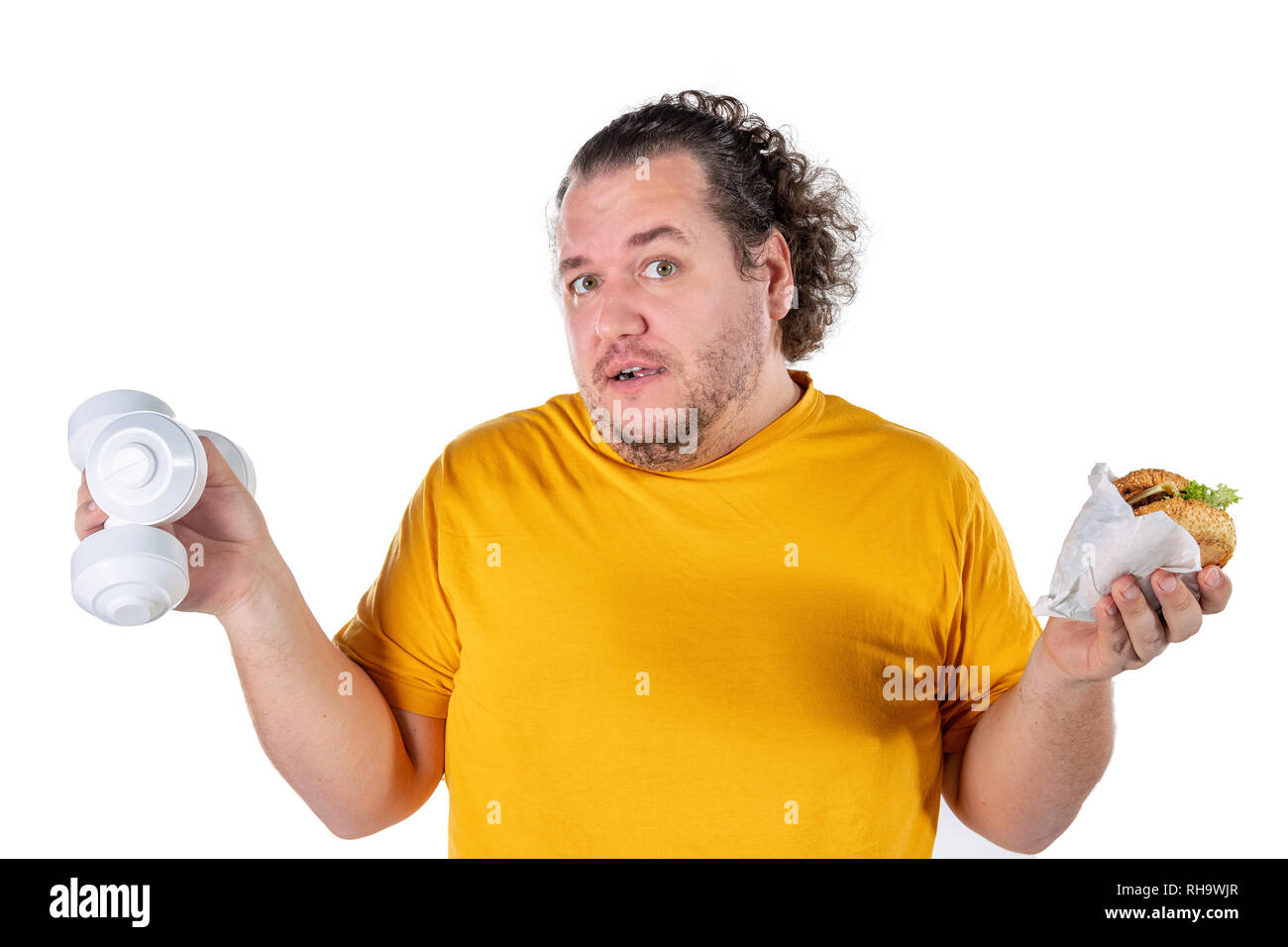 Funny fat man eating unhealthy food and trying to take exercise isolated Stock Photo