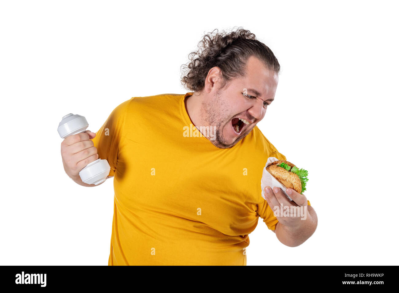 Funny fat man eating unhealthy food and trying to take exercise isolated Stock Photo