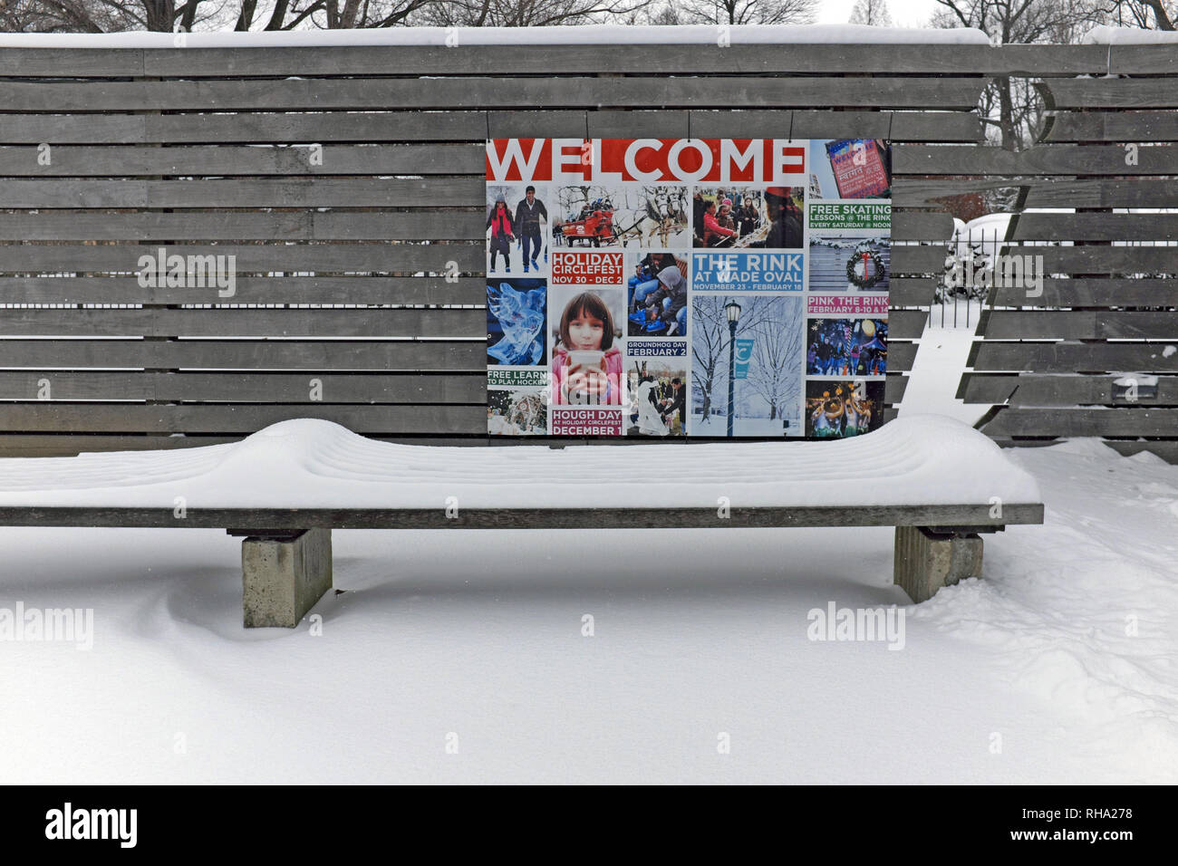 Winter snow covers a bench in Wade Oval in the University Circle district of Cleveland, Ohio, USA Stock Photo