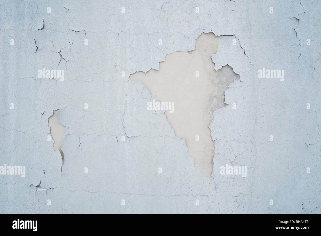 Gray peeling paint on old wall for background or texture. Stock Photo