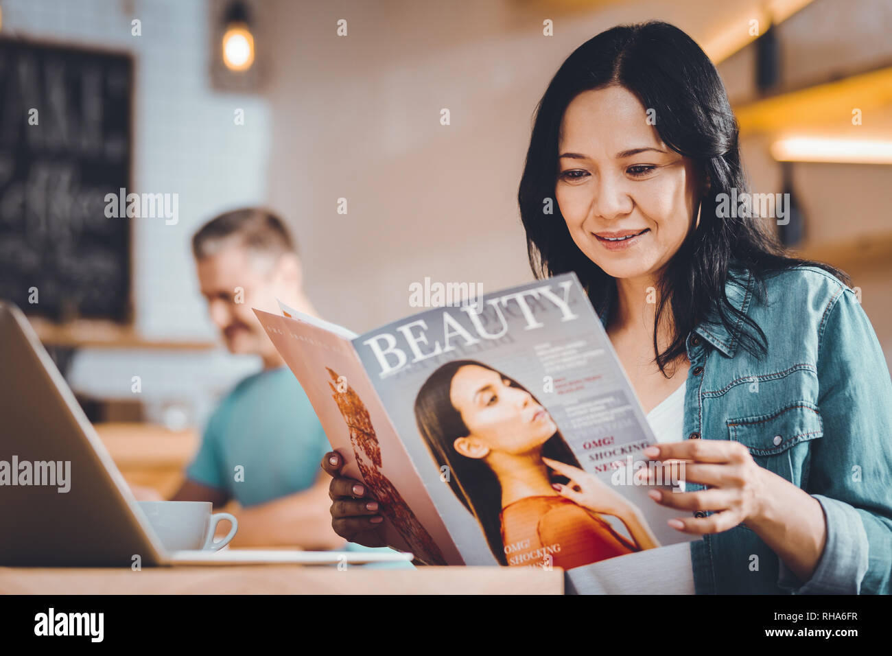 Concentrated woman reading a magazine Stock Photo Alamy