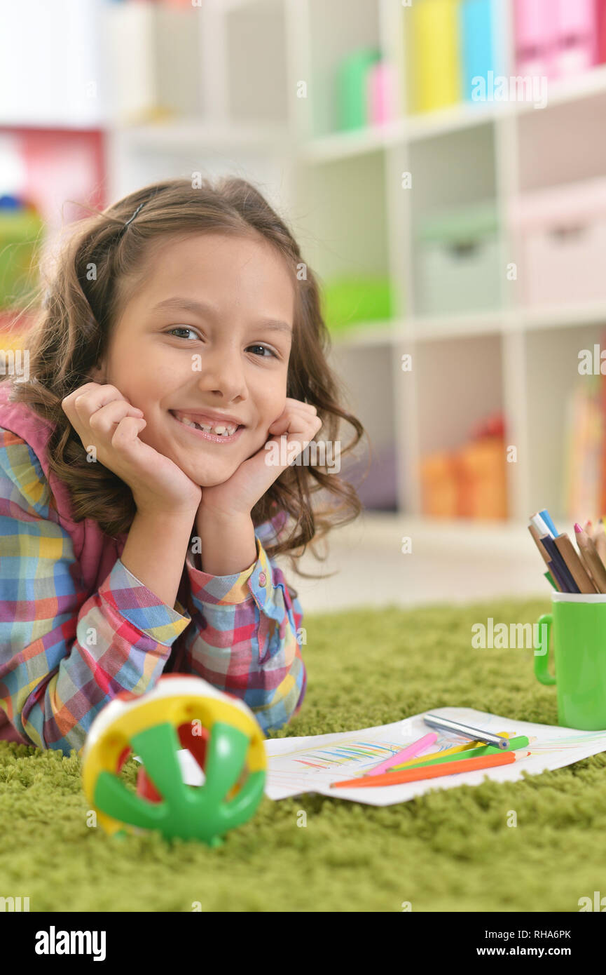 cute girl lying on floor and drawing Stock Photo - Alamy