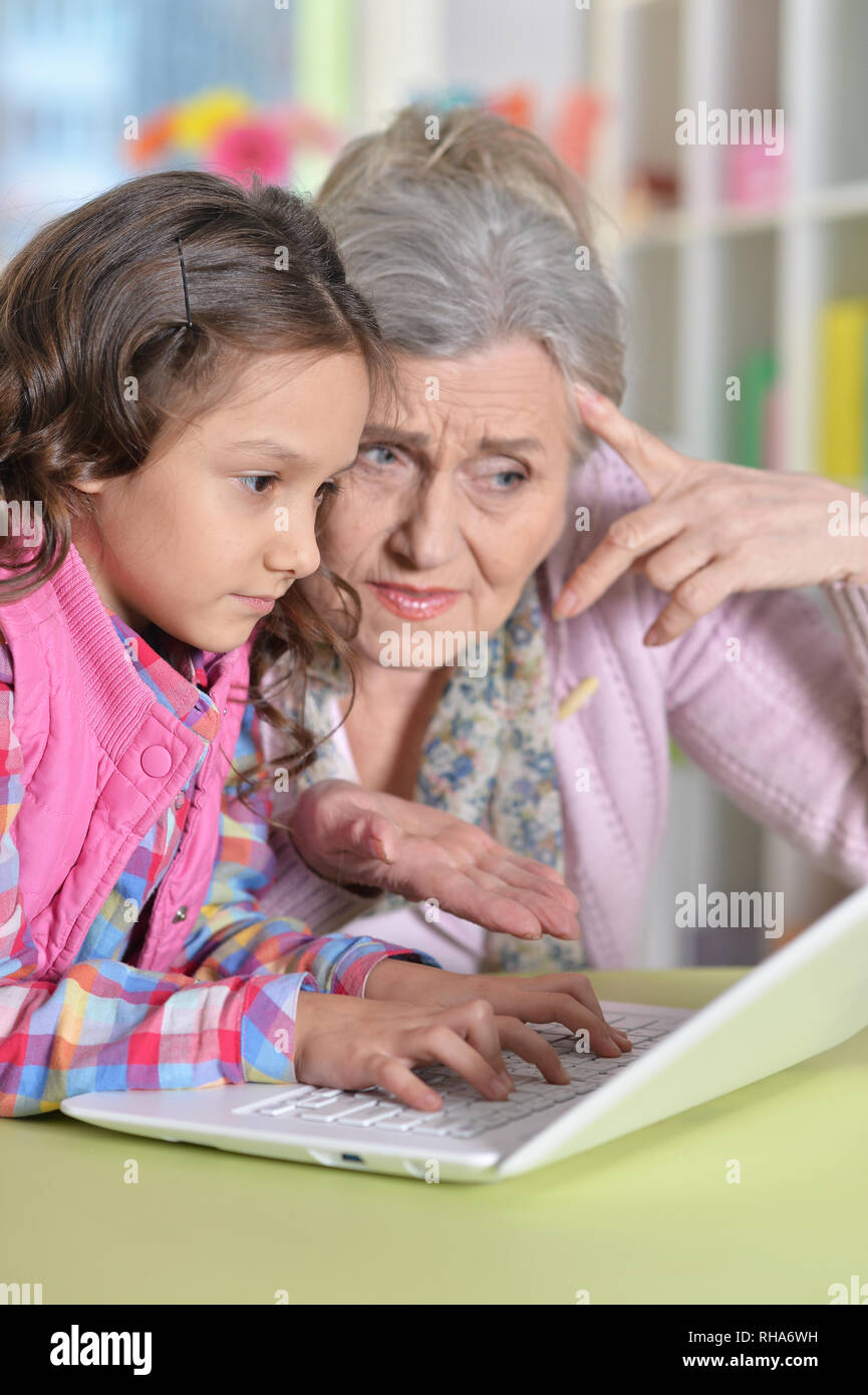 portrait of grandmother and daughter using modern laptop Stock Photo ...