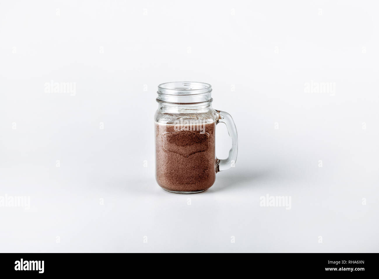 https://c8.alamy.com/comp/RHA6XN/fresh-protein-shake-milk-with-cocoa-in-a-glass-jar-on-a-white-background-RHA6XN.jpg