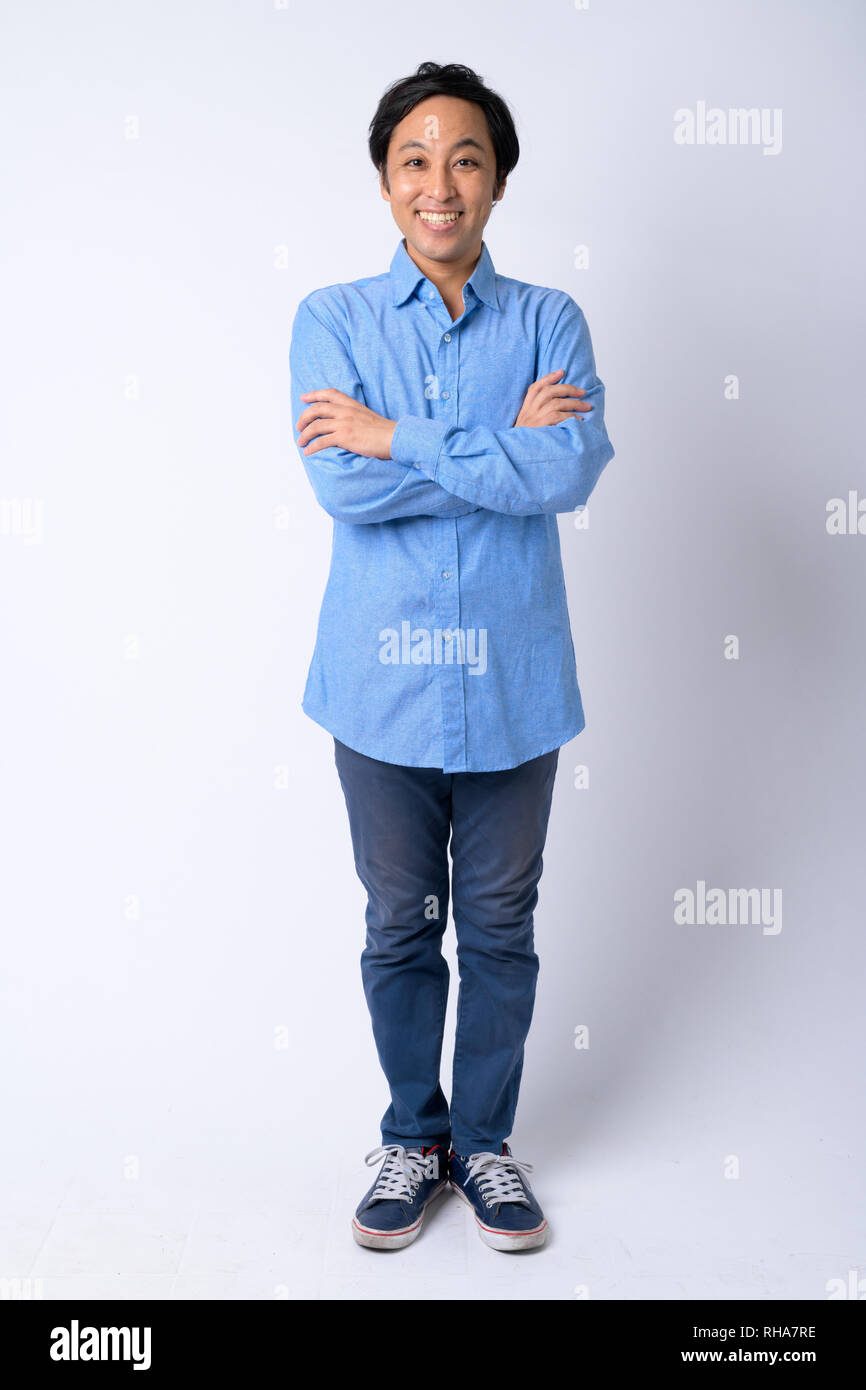 Full body shot of happy Japanese businessman smiling with arms crossed ...