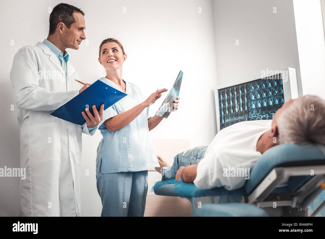 Two professional doctors feeling contended after getting results of x-ray Stock Photo