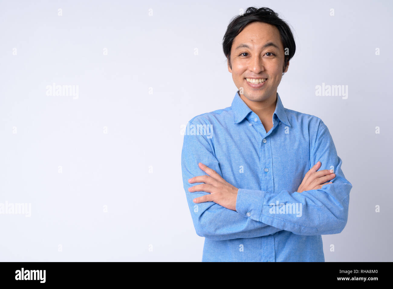 Portrait of happy Japanese businessman smiling with arms crossed Stock ...