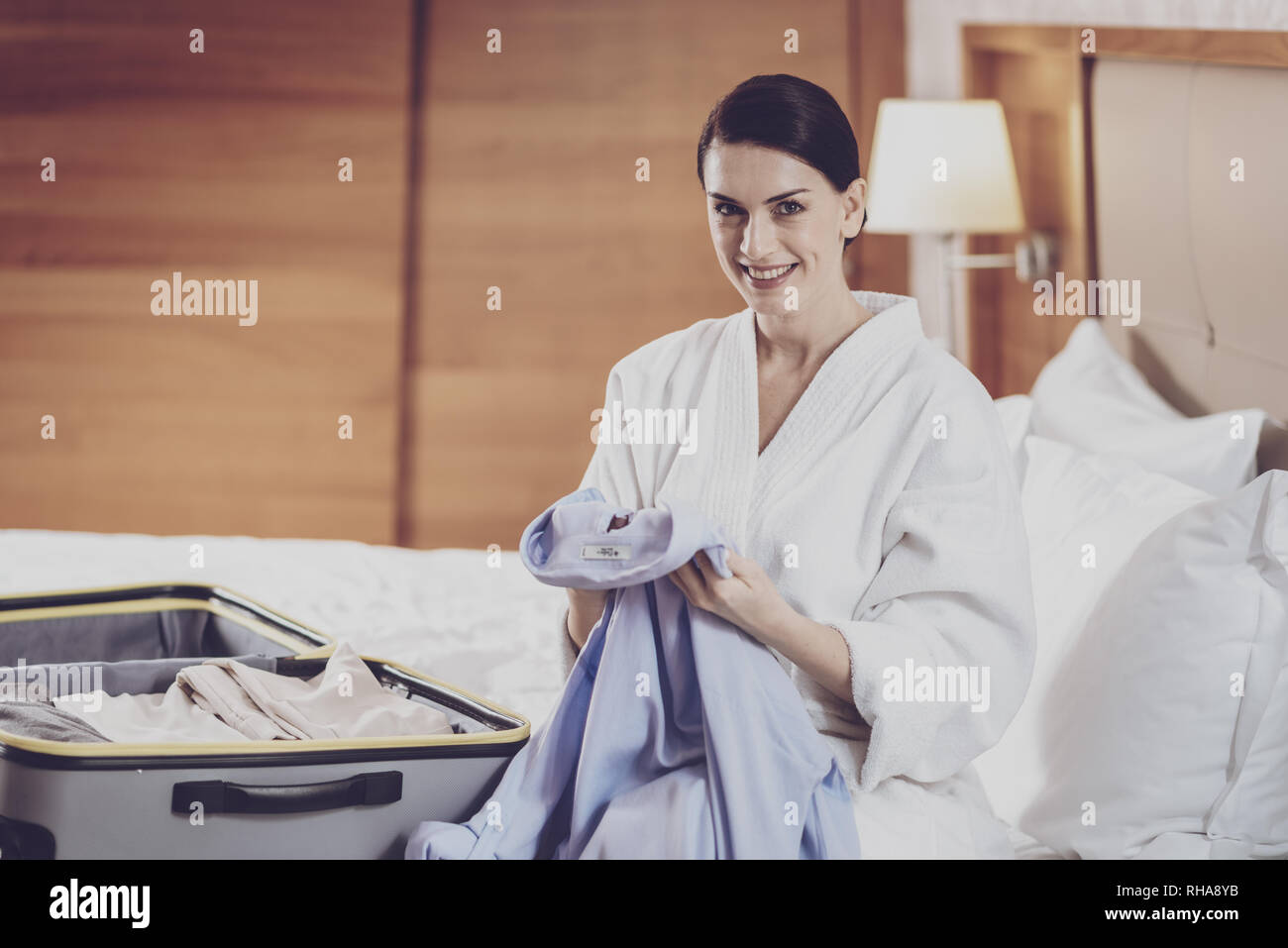 Beautiful woman folding clothes in a suitcase Stock Photo Alamy
