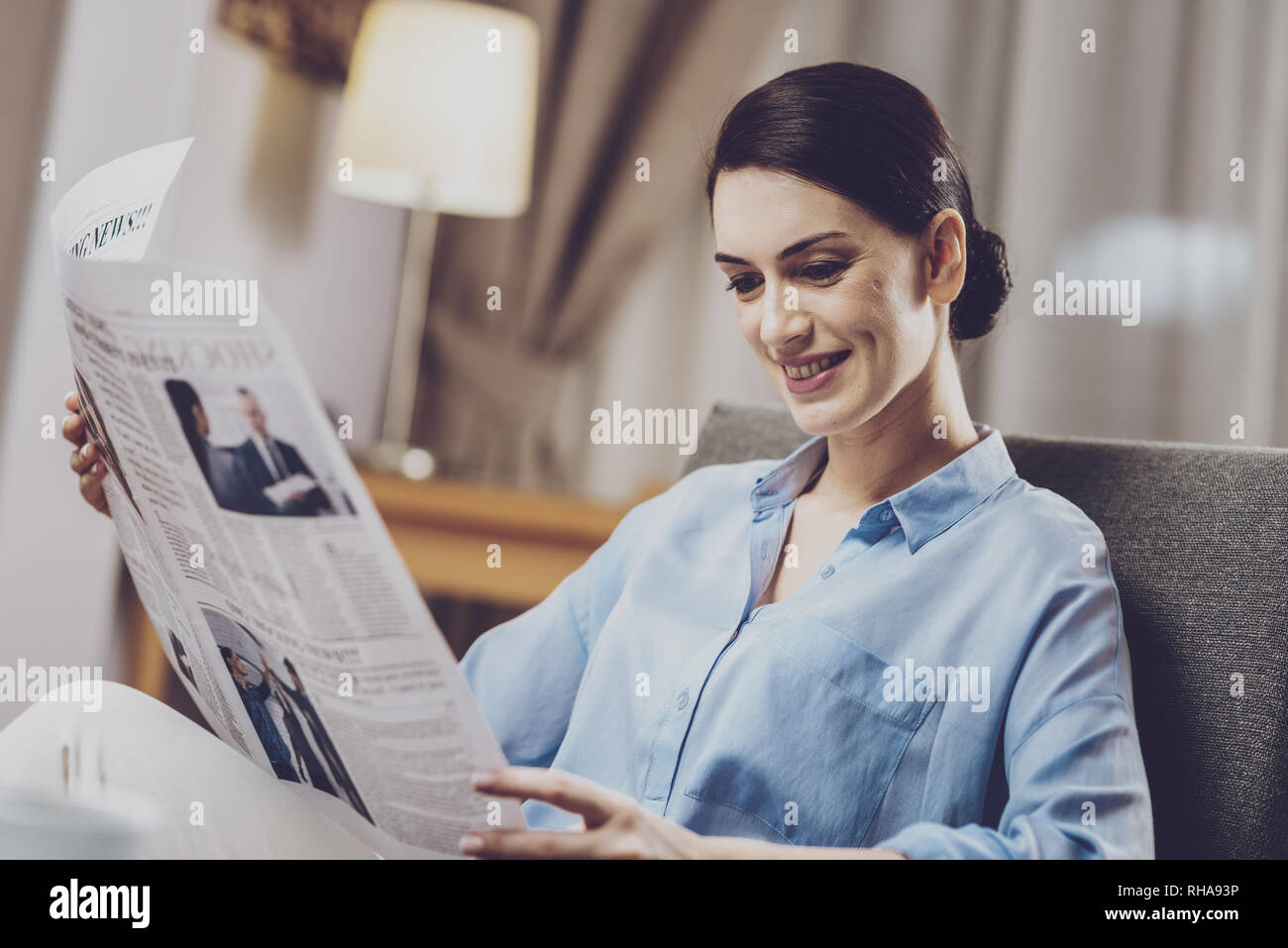 Positive woman reading news reports Stock Photo