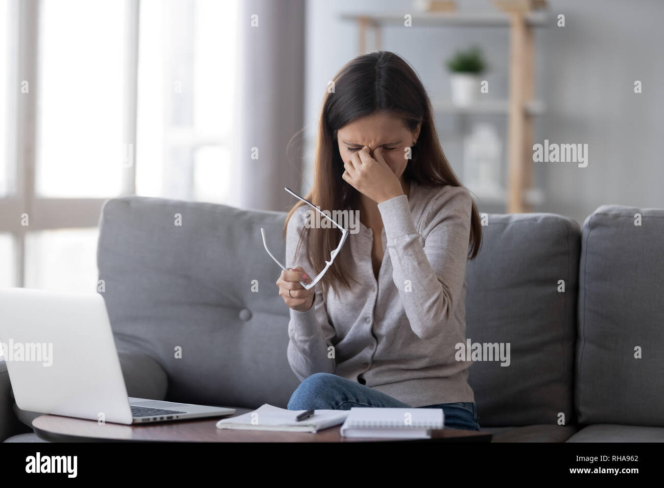 Tired eyes from computer concept, fatigued teen girl feeling eyestrain Stock Photo