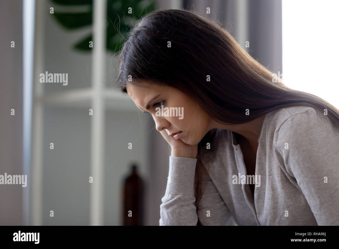 Gloomy upset young woman feeling bad depressed and lonely Stock Photo