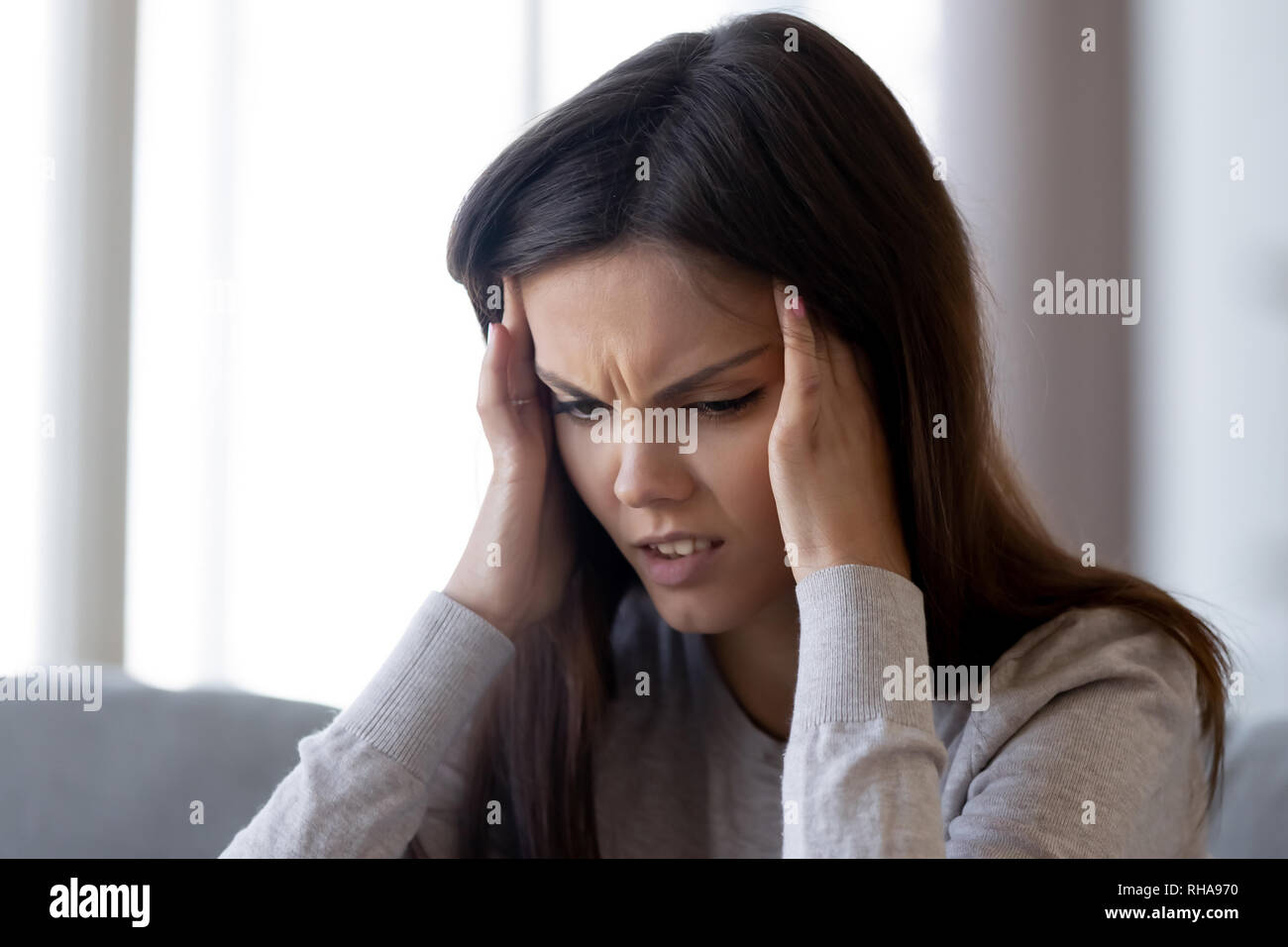 Upset stressed young woman feeling pain strong headache concept Stock Photo