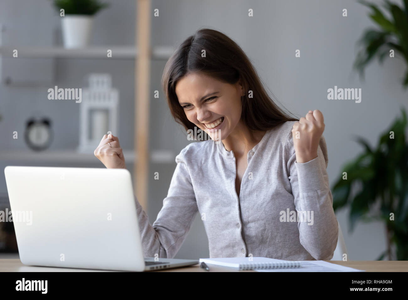 Excited ecstatic teen girl winner celebrating victory looking at laptop Stock Photo