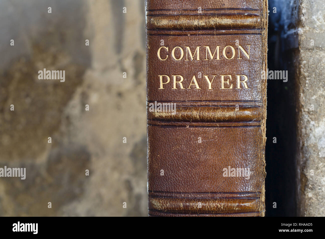 Detail of an old leather-bound christian prayer book with a stone background and copy space Stock Photo
