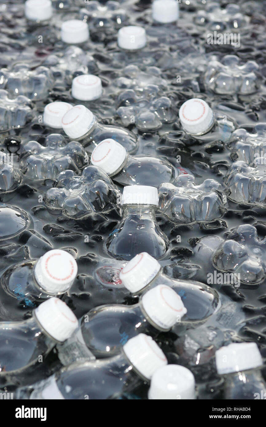 Bottles of water sit in a cooler of ice water on a hot day Stock Photo Alamy