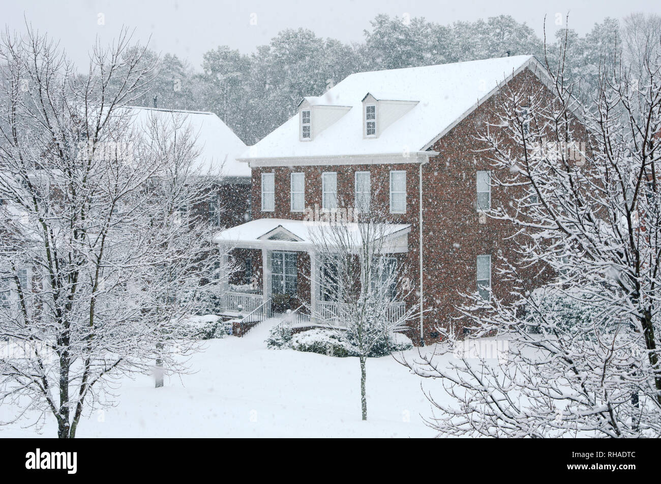 Traditional Brick Homes in a Neighborhood Covered in Snow After a Storm