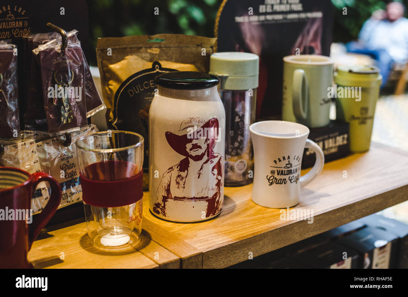 Official Juan Valdez coffee merchandise in a brand flagship café in Bogotá, Colombia - branded coffee, flasks and mugs Stock Photo