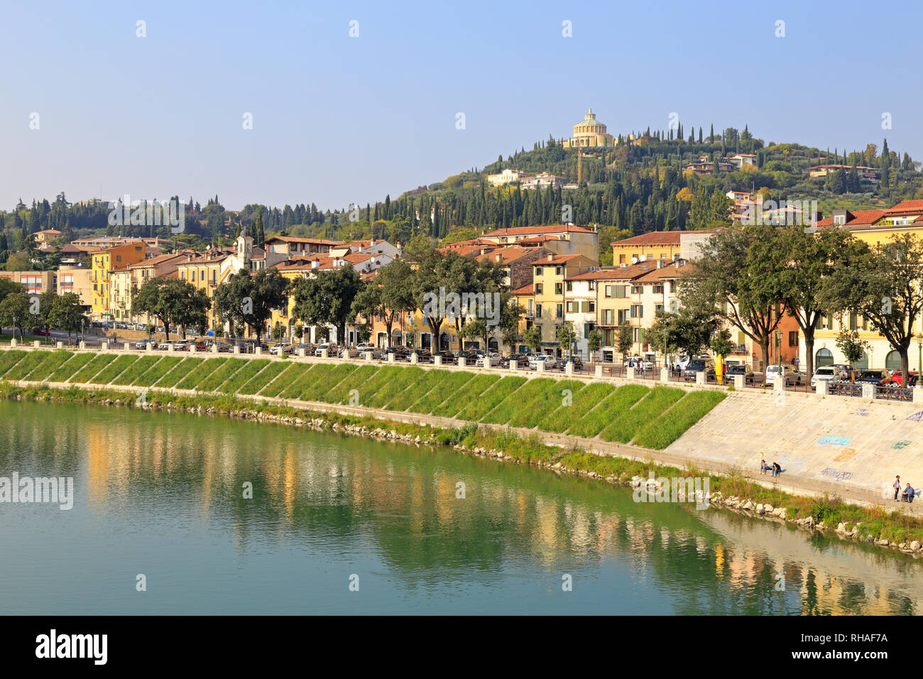 Adige River and distant hilltop Sanctuary our Lady of Lourdes from the Ponte Pietra, Verona, Veneto, Italy. Stock Photo