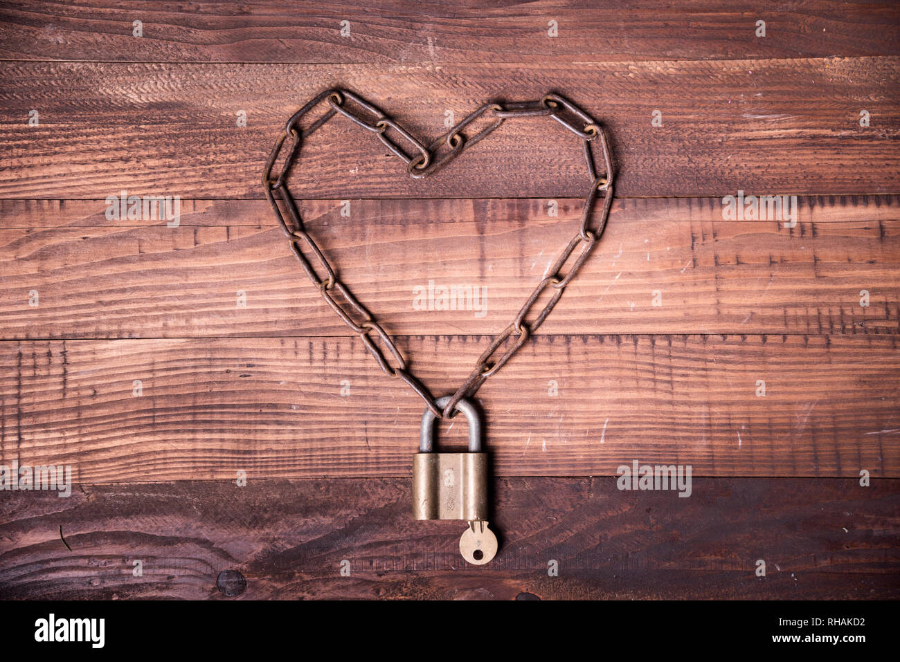 Valentine's day background design. Top view of valentine heart with locked  chain and key Stock Photo - Alamy