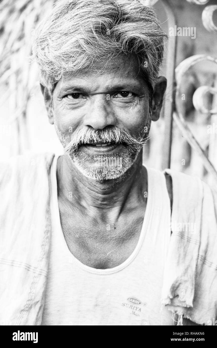 PUDUCHERRY, INDIA - DECEMBER Circa, 2018. Unidentified portrait close-up of old face indian man looking at the camera, smiling. Black and white image Stock Photo
