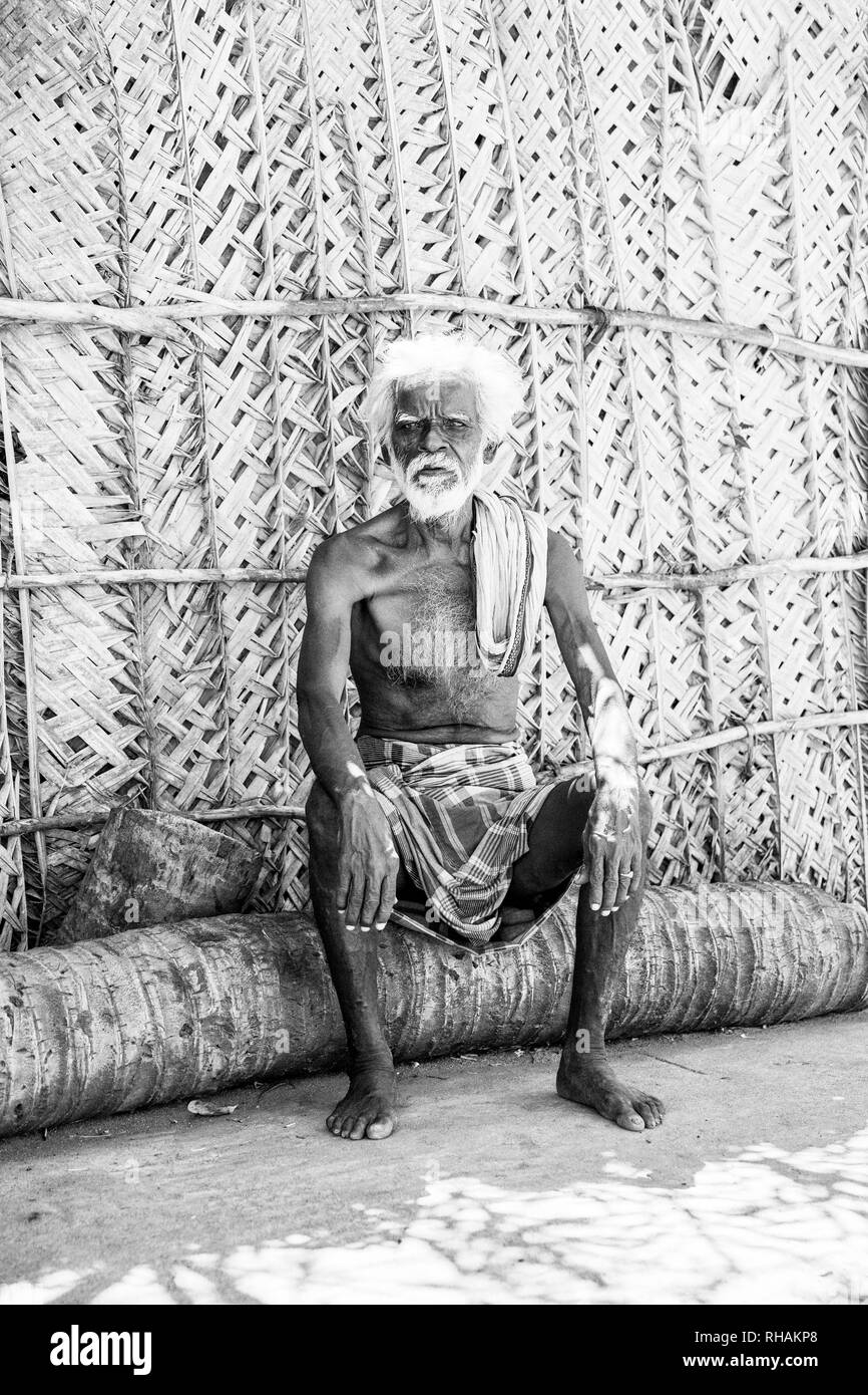 PUDUCHERRY, INDIA - DECEMBER Circa, 2018. Unidentified portrait of old face indian man sitting outdoor in village, looking at the camera,very serious. Stock Photo