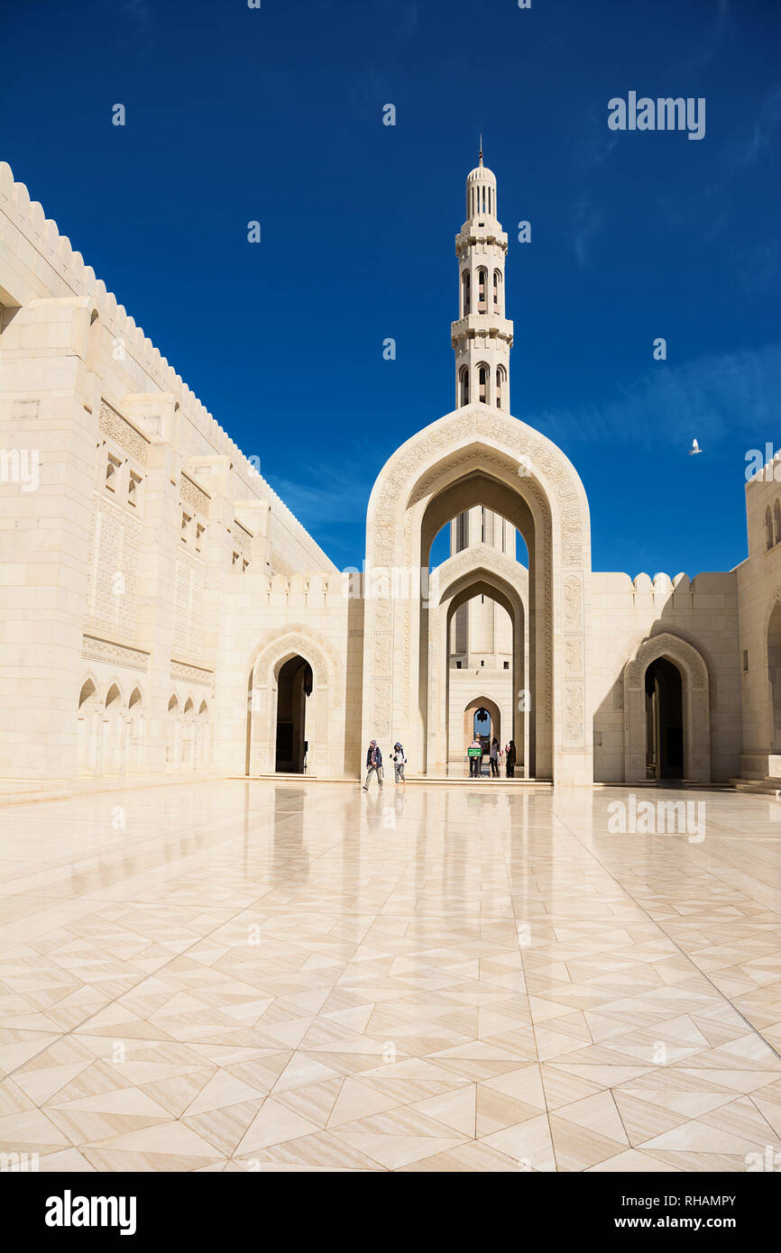Muscat, Oman - November 4, 2018: Faithful under minaret at the Grand Mosque in Muscat (Oman) Stock Photo
