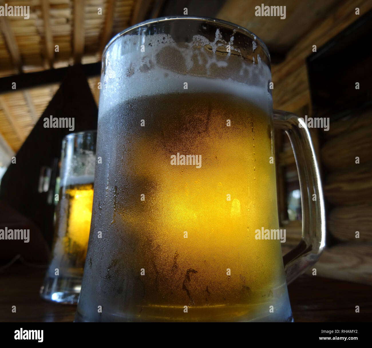 Two pints of craft beer with froth on the glass on the wood table Stock Photo