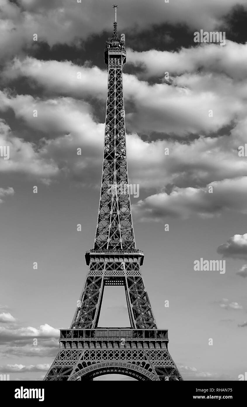 Eiffel Tower also called Tour Eiffel in french language with black and white effect and many clouds Stock Photo