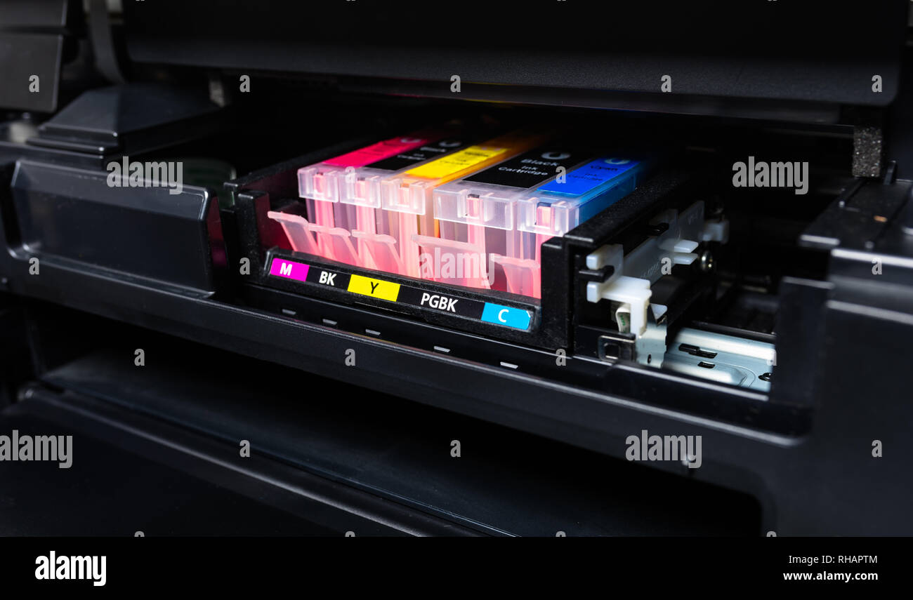 Close-up shot of a CMYK ink cartridges in a color printer Stock Photo ...