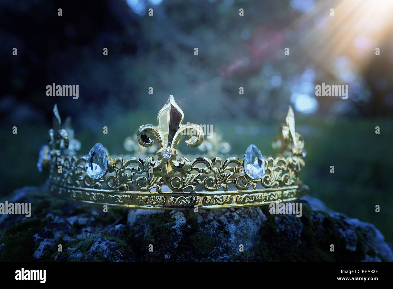 mysterious and magical photo of gold king crown over the stone covered ...