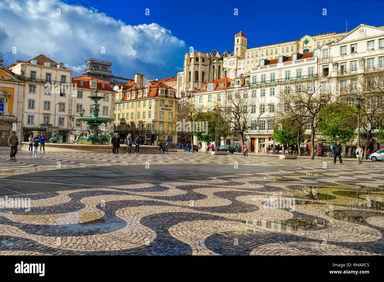 People walk in Dom Pedro IV square, also called Rossio, in Lisbon, Portugal Stock Photo