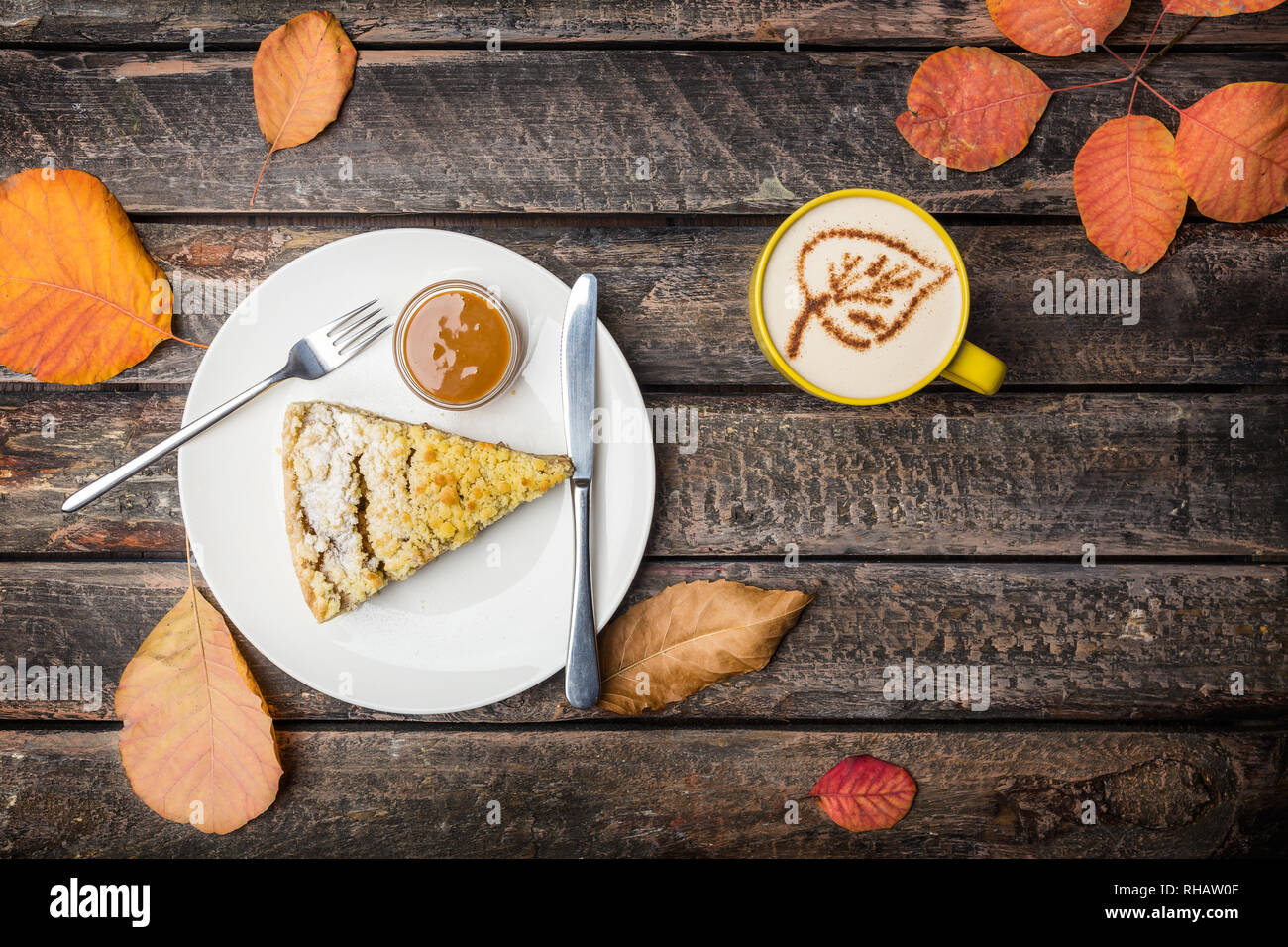 Apple pie with cutlery and coffee on a white dish, on a beautiful wooden background. Top view Stock Photo