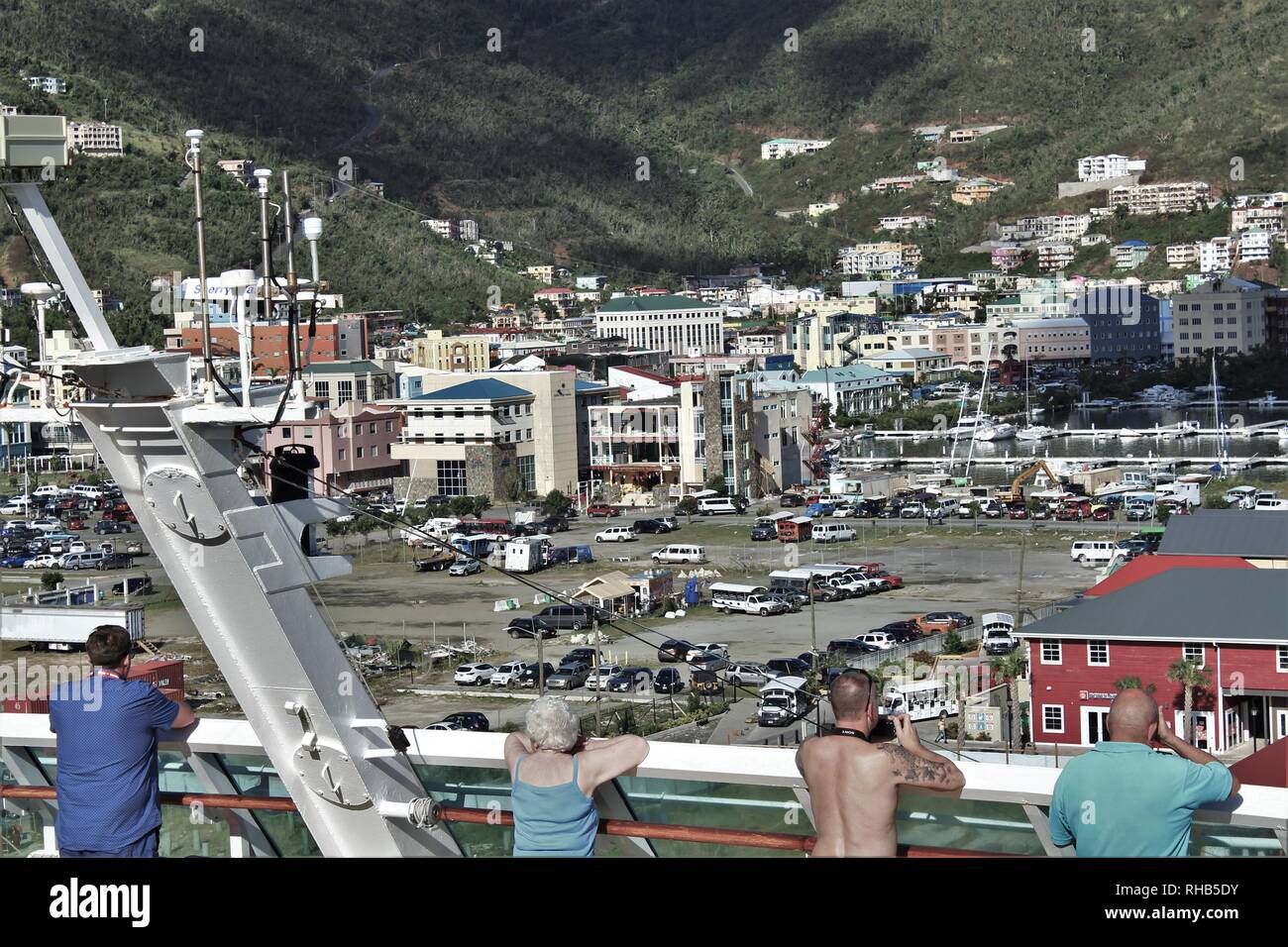 February 28th 2018: Tourists on a newly arrived cruise ship survey Road Town, which is still largely destroyed from Hurricane Irma five months before. Stock Photo