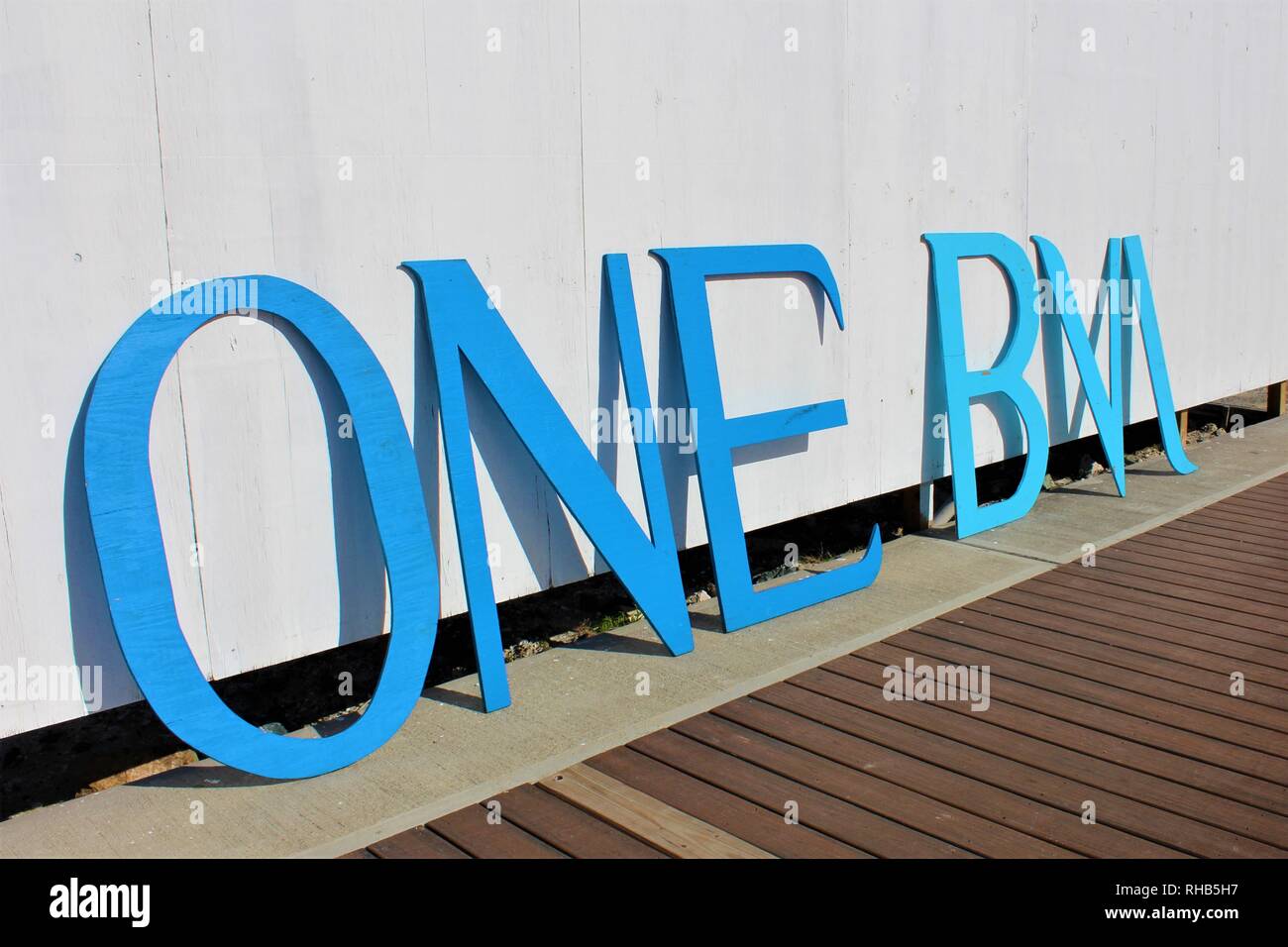 The 'One BVI' tourist board logo leans against a wall at Road Town port, to welcome cruise ship visitors after the destruction left by Hurricane Irma. Stock Photo