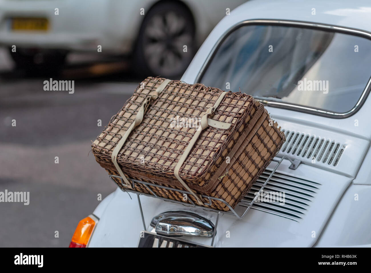 Handmade wicker picnic basket over white car boot Stock Photo
