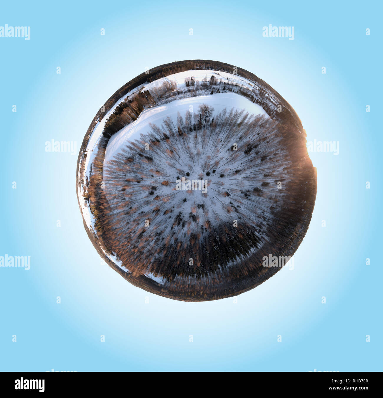 360-degree mini planet panorama of a snowy winter forest in Hämeenlinna, Finland. Snow covered fields and sunlight hitting the trees in evening light. Stock Photo