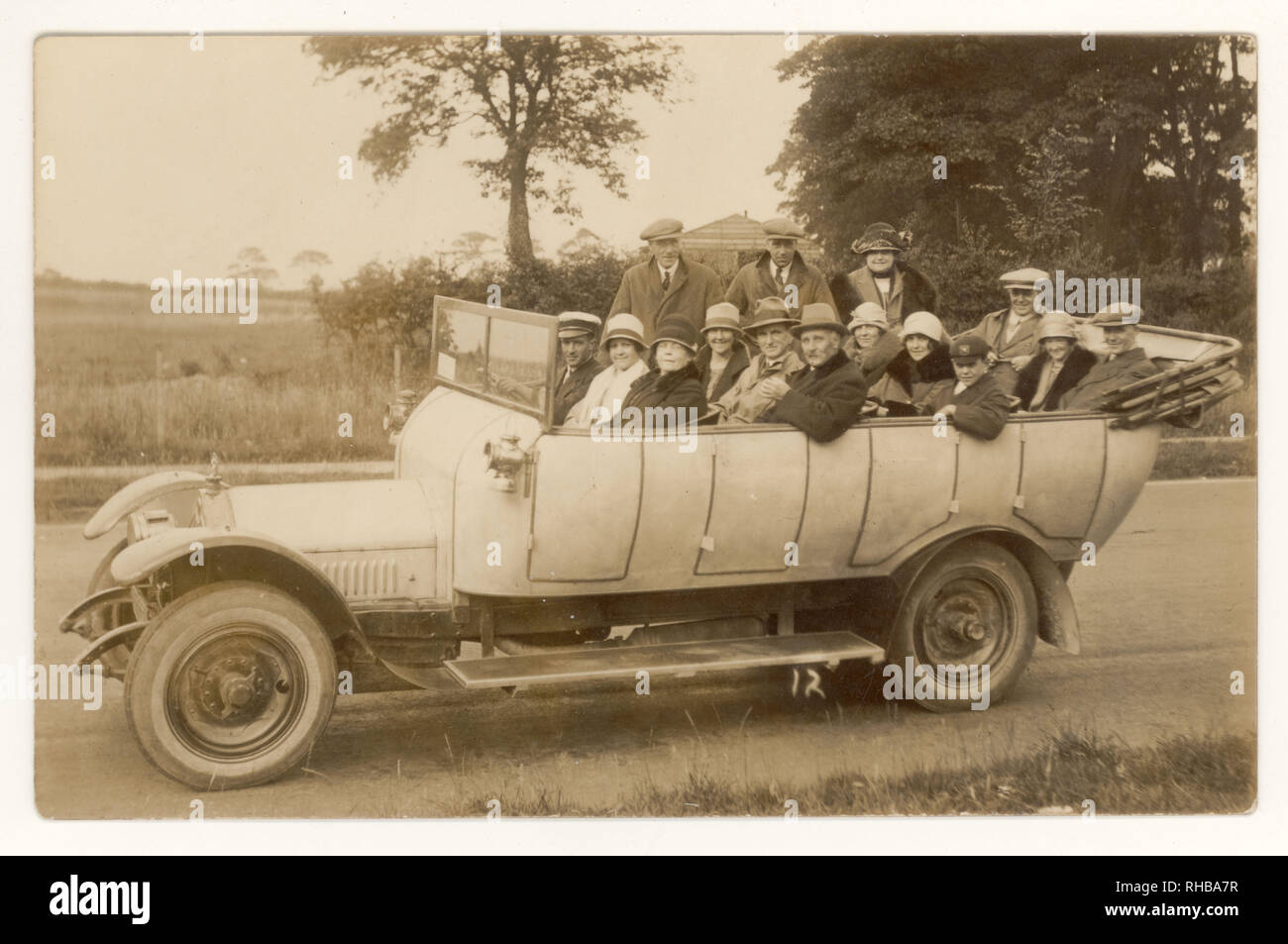 Early 1900's postcard of charabanc outing in countryside, circa 1925, women wear fashionable cloche hats, U.K. Stock Photo