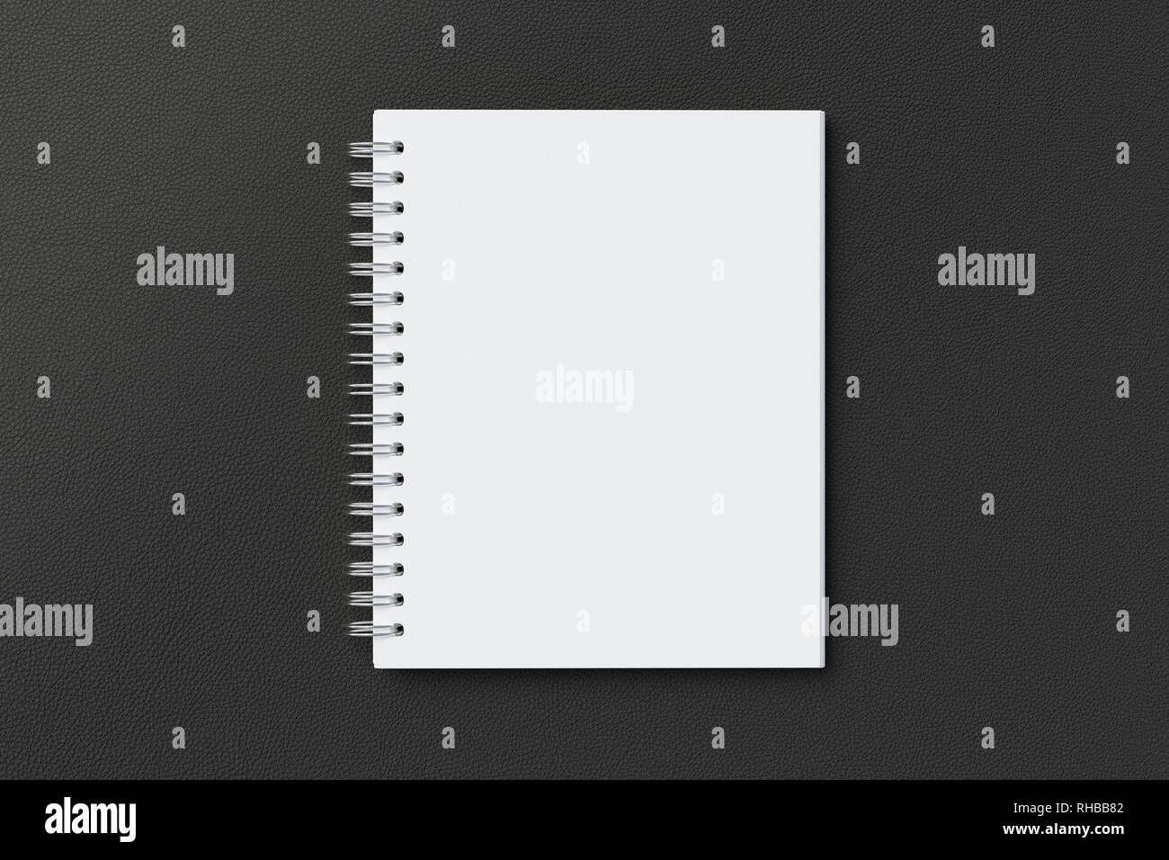 Blank vertical spiral notepad on black background. With clipping path around notebook pages Stock Photo