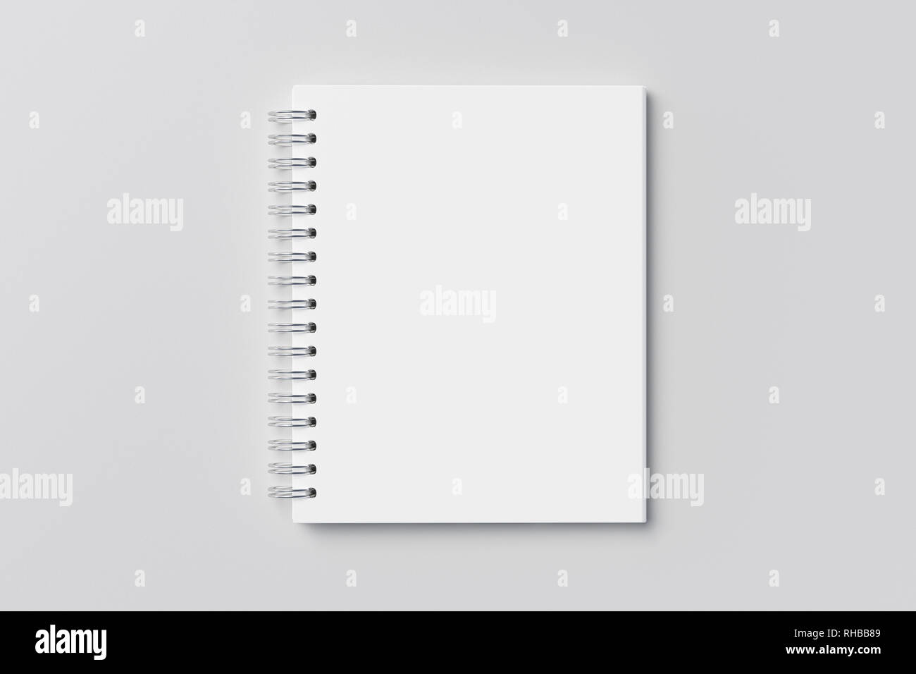 Blank vertical spiral notepad on white background. With clipping path around notebook pages Stock Photo