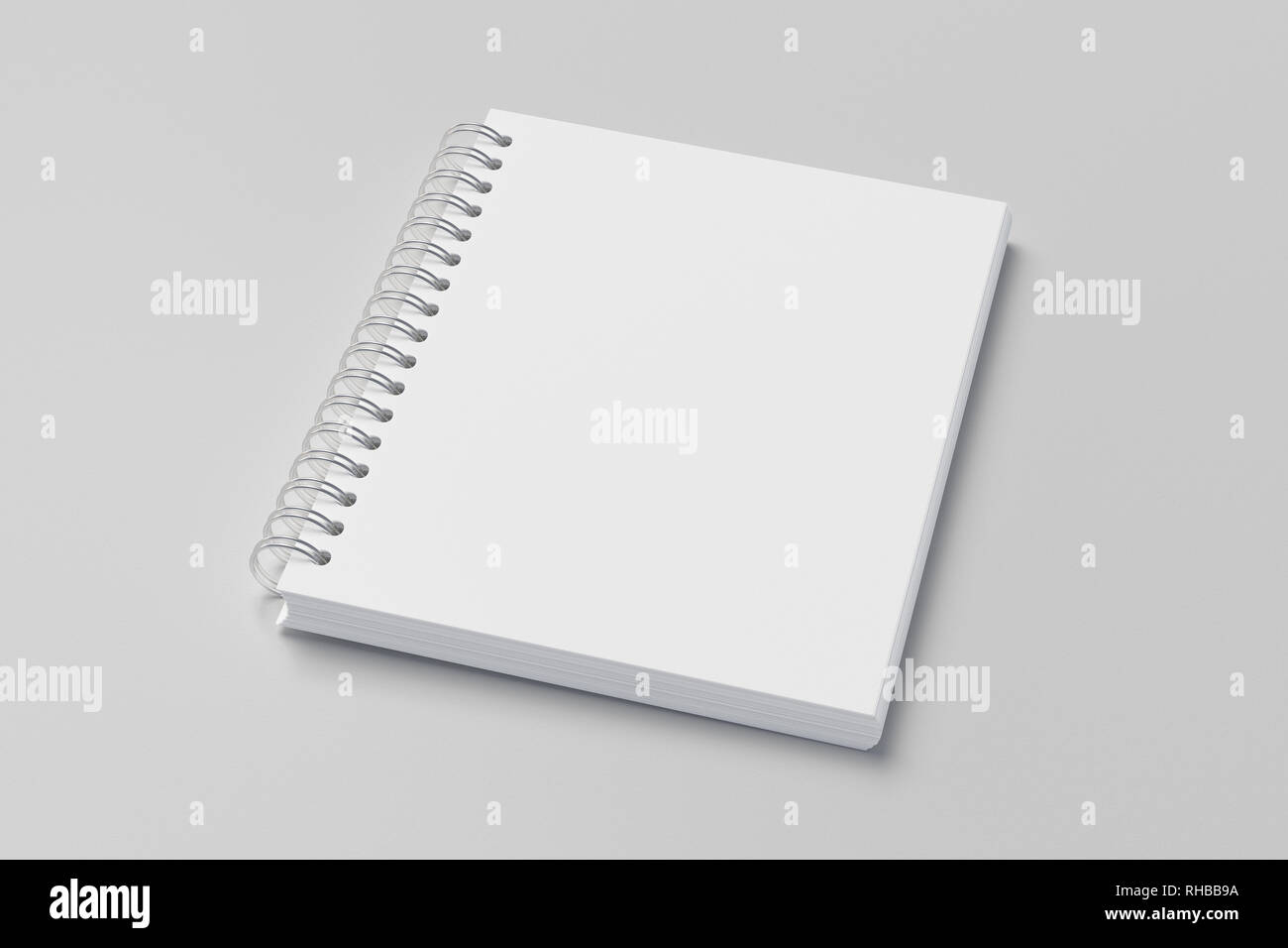 Blank vertical spiral notepad on white background. With clipping path around notebook pages Stock Photo