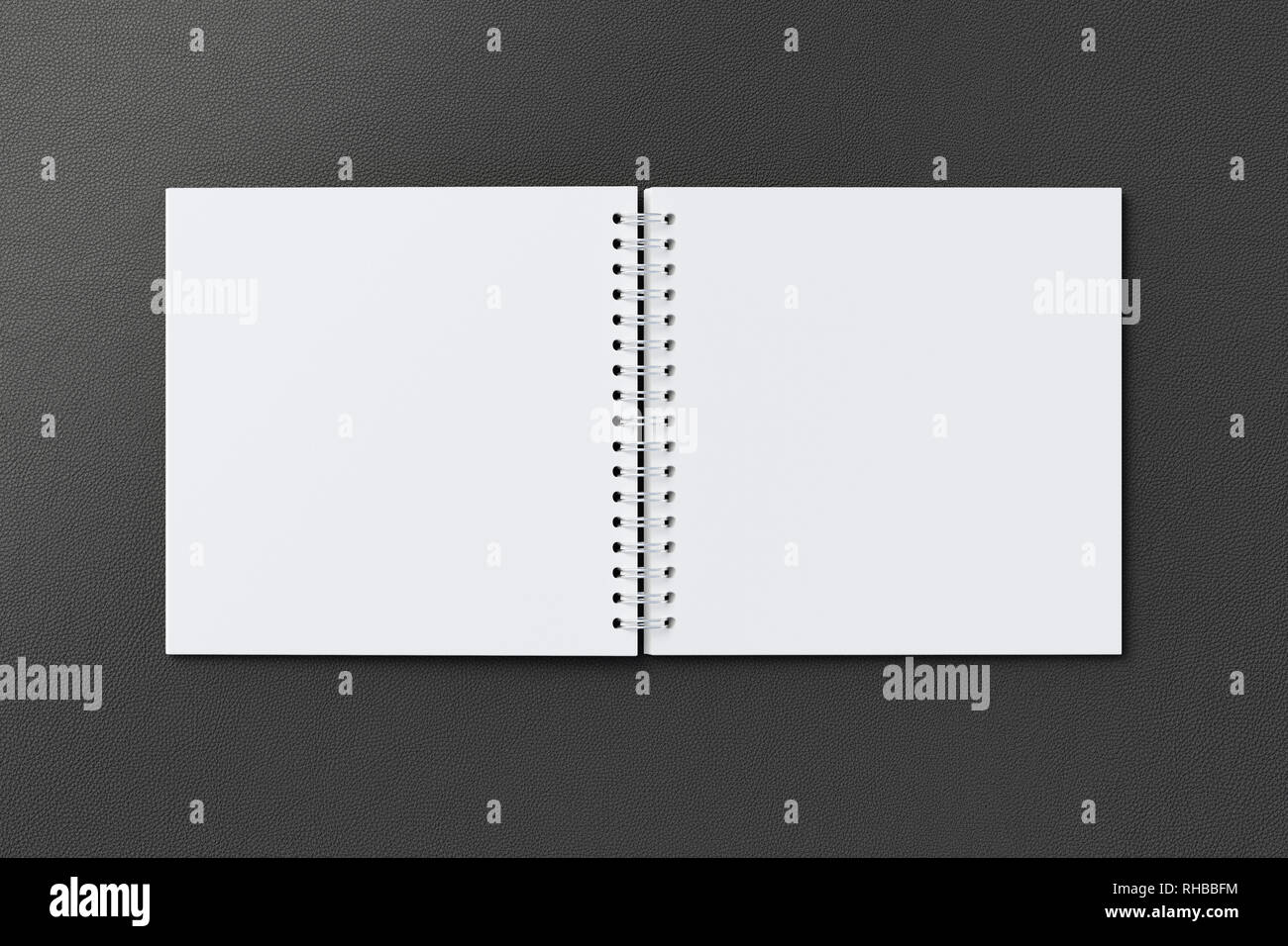 Blank open square spiral notepad on black background. With clipping path around notebook pages Stock Photo