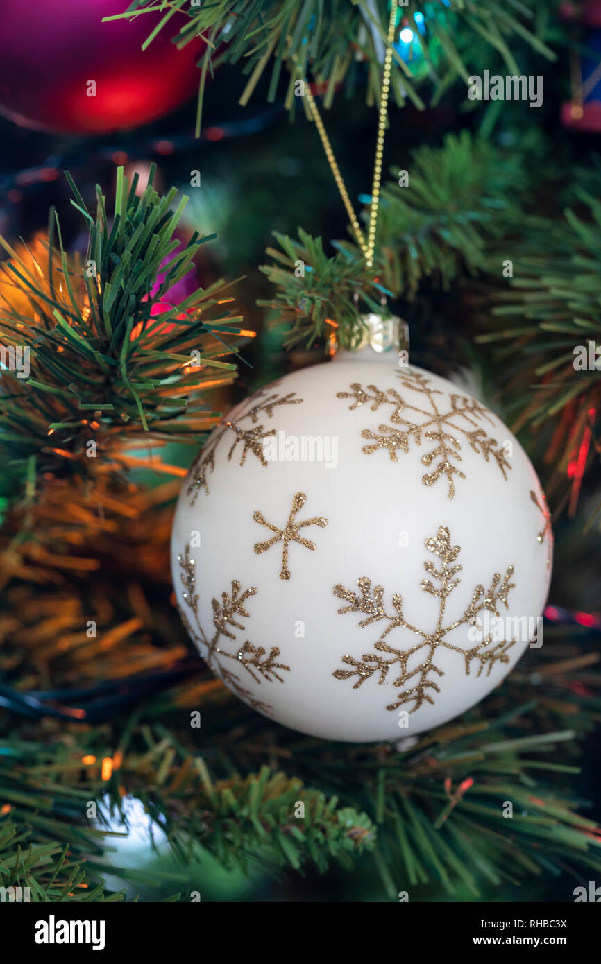 Close up of a snowflake Christmas bauble hanging on a Christmas tree Stock Photo