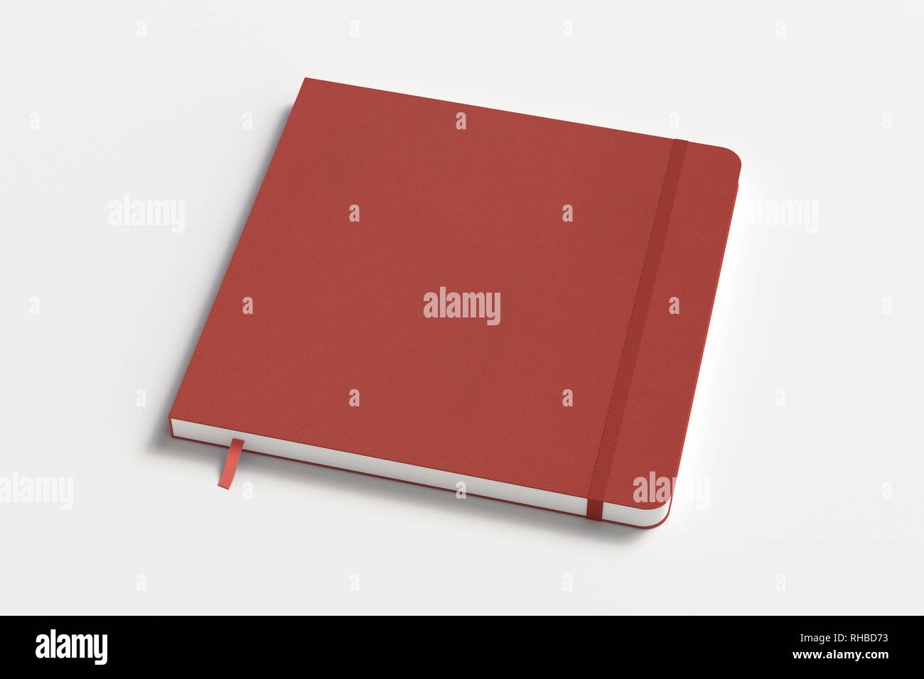 Red square notebook with elastic band on white background Stock Photo