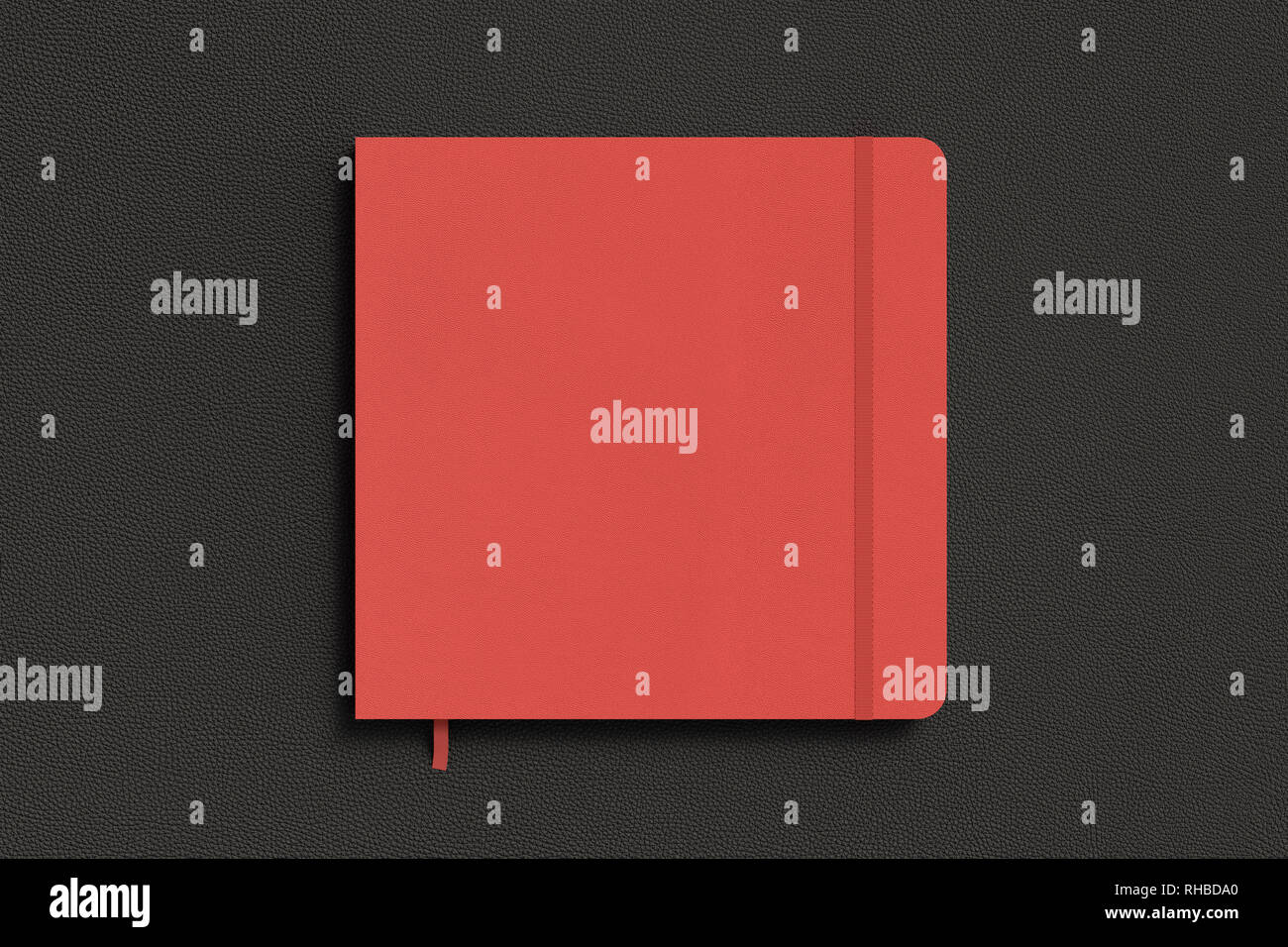 Red square notebook with elastic band on black background Stock Photo