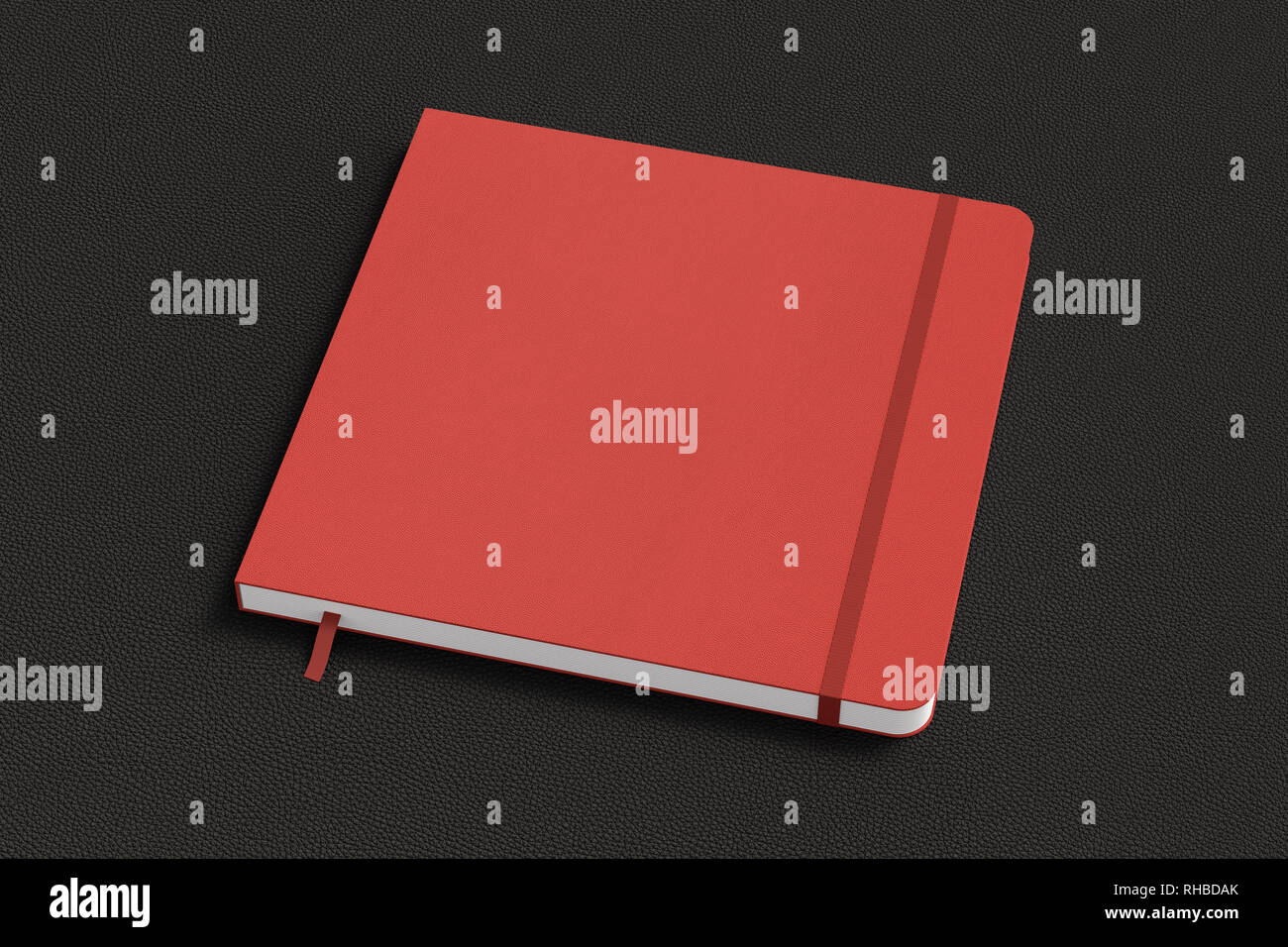 Red square notebook with elastic band on black background Stock Photo