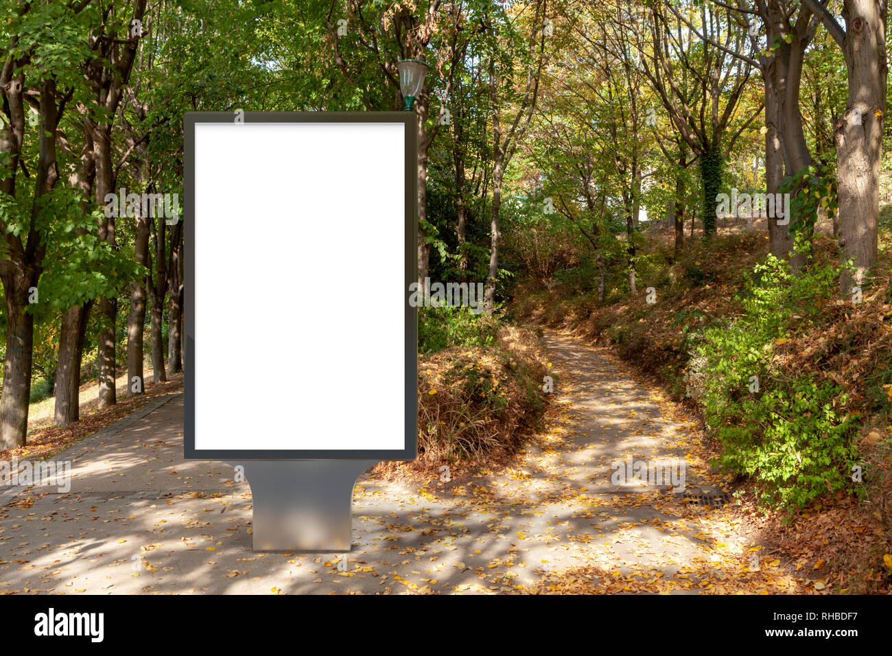 Blank street billboard poster stand in the park Stock Photo - Alamy