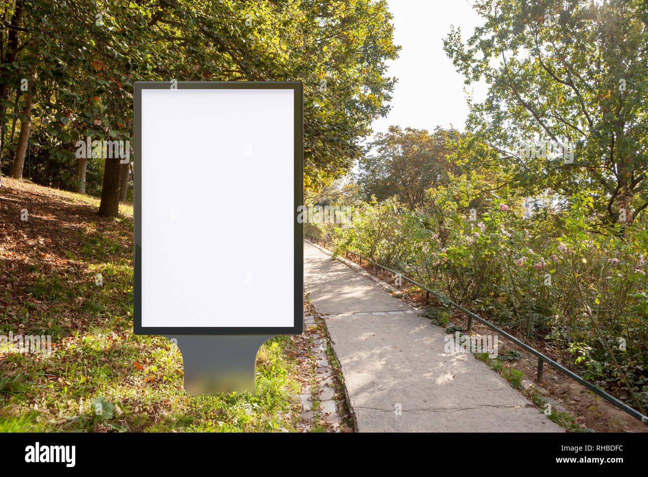 Blank street billboard poster stand in the park Stock Photo - Alamy